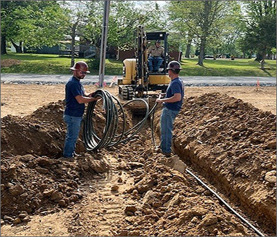 Utility Workers Laying Pipeline